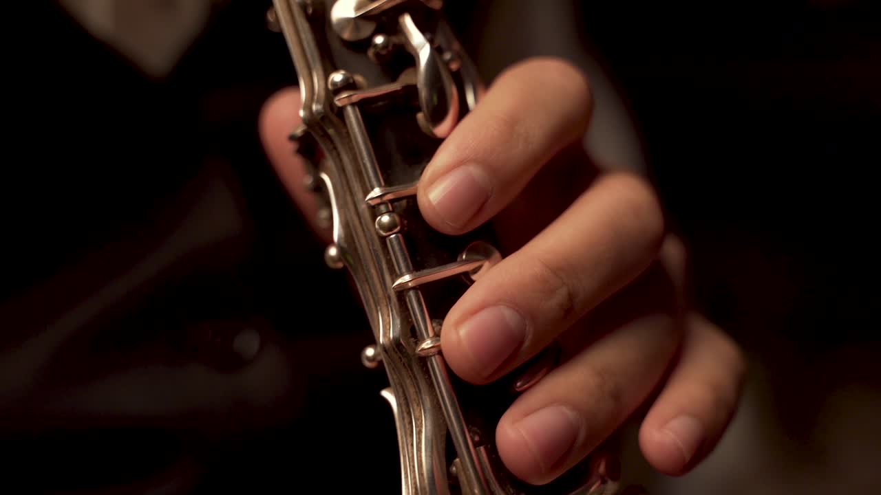 fingers player on Clarinet, in a dark room.  Super Close Up, Hasidic Jewish player