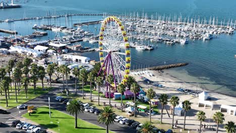 drone footage of a ferris wheel near beach