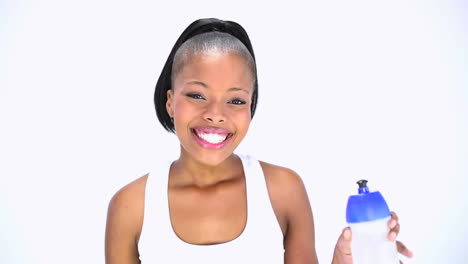 Smiling-model-in-sportswear-holding-flask