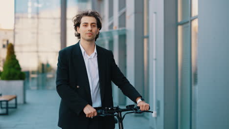 young businessman with electric scooter in modern city environment