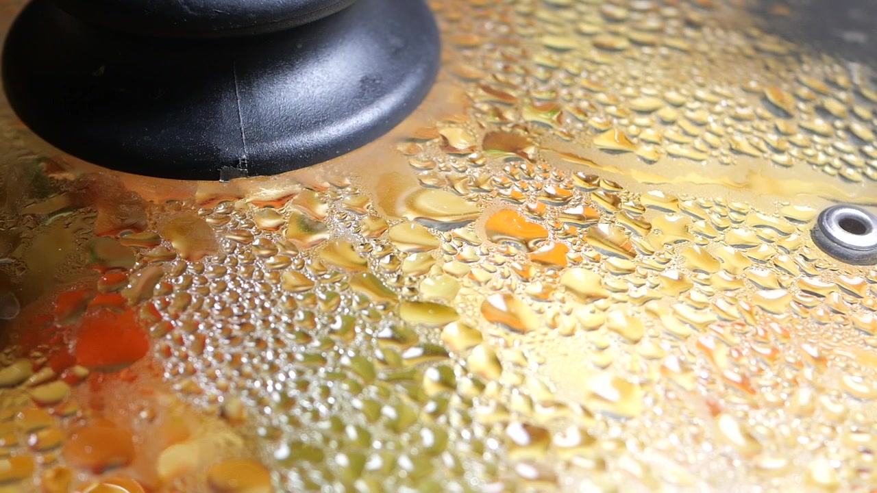 Steam Condensing on a Glass Pot Lid While Food Cooks