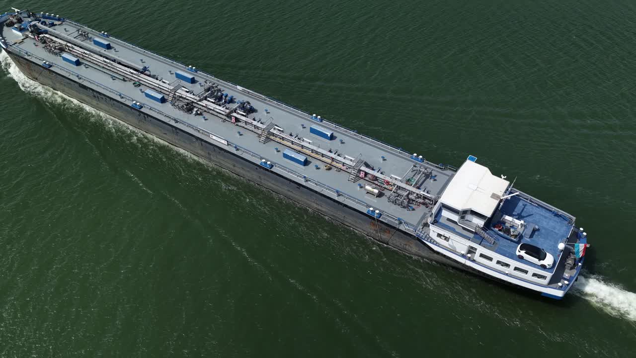 Aerial view of a cargo ship sailing, peaceful and serene