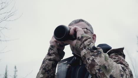 man taking picture in forest