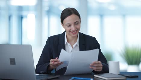 Happy-Indian-business-woman-checking-reports