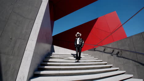 stylish man posing on modern stairs