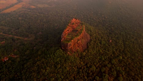 soaring above the misty jungles of sri lanka, this drone clip captures the iconic sigiriya rock at sunrise.