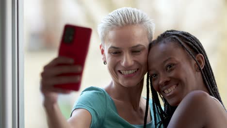 two happy friends taking a selfie with a mobile phone