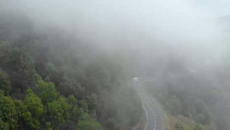 bus driving on foggy mountain road
