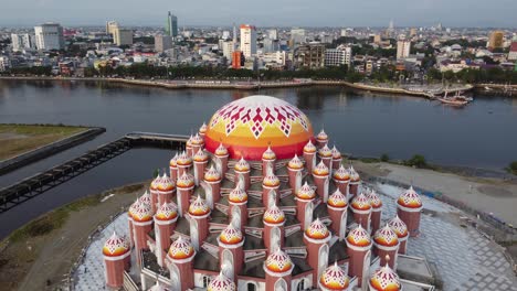 aerial view of a colorful mosque dome and a bustling city waterfront