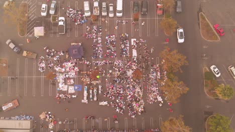 Aerial-pullback-shot-through-smoke-of-parking-lot-distribution-for-Camp-Fire-evacuees-in-California