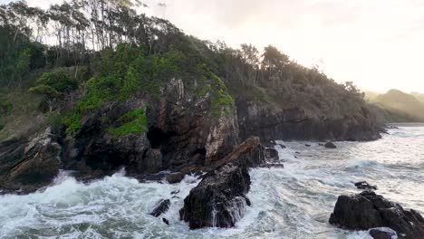 rocky cliffs and ocean waves at charlesworth bay beach, coffs harbour, captured in soft, natural lighting