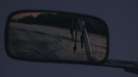 Rear-view-mirror-of-motor-boat.-Water-trail-behind-of-fast-moving-motor-boat