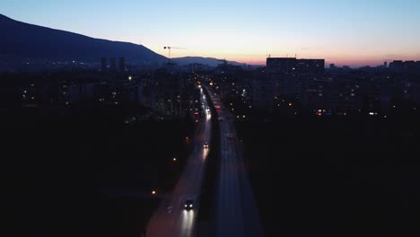 Drone-flight-over-Boulevard-Andrey-Lyapchev-in-Sofia,-Bulgaria-at-dusk