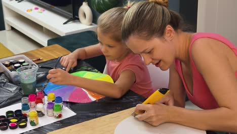 mother and daughter painting together