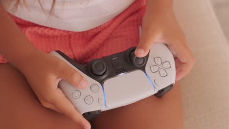 child holding playstation 5 controller