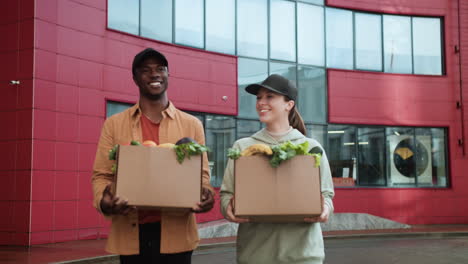 couriers holding boxes outdoors