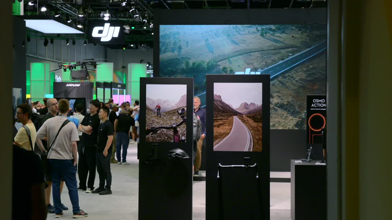 Floor Standing Digital Signages Showing Footage Filmed With DJI Cameras At IFA Exhibit In Berlin, Germany. dolly-in, tilt-up shot