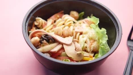 pasta salad in a black bowl