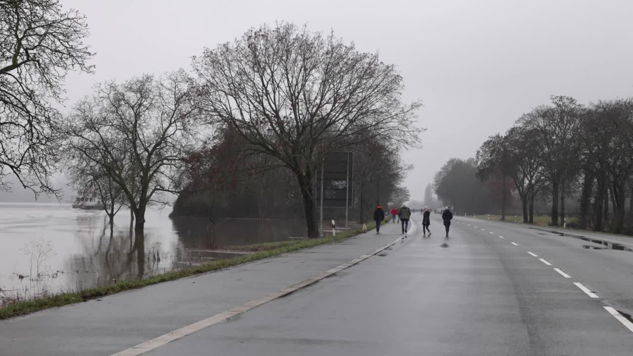 People Walks On The Empty Road Of Rudesheim, Germany On A Gloomy Day. wide shot