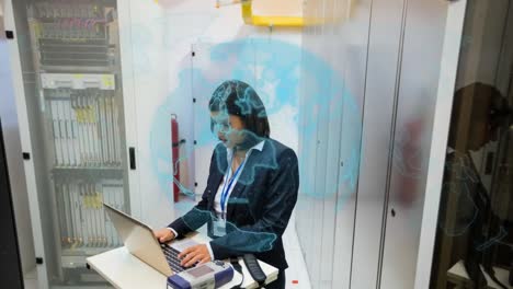 Animation-of-globe-over-biracial-female-worker-using-laptop-in-server-room