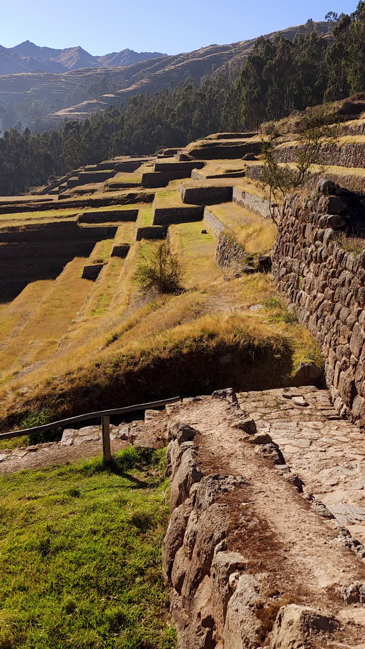 A breathtaking panoramic view of the ancient Inca agricultural terraces in Chinchero, Peru. The impressive engineering of the Incas and the stunning Andean mountain landscape