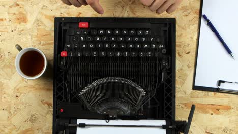 hands repairing an old typewriter