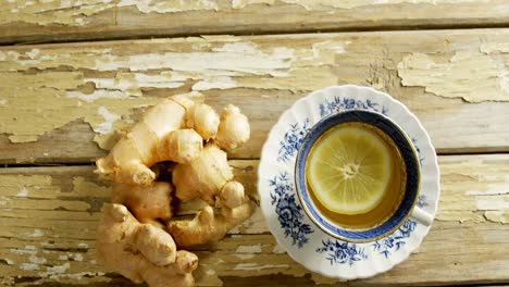 Cup-of-lemon-tea-with-ginger-on-wooden-floor-4K-4k
