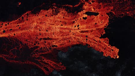 fiery red burning lava on earth surface, effusive eruption, top down