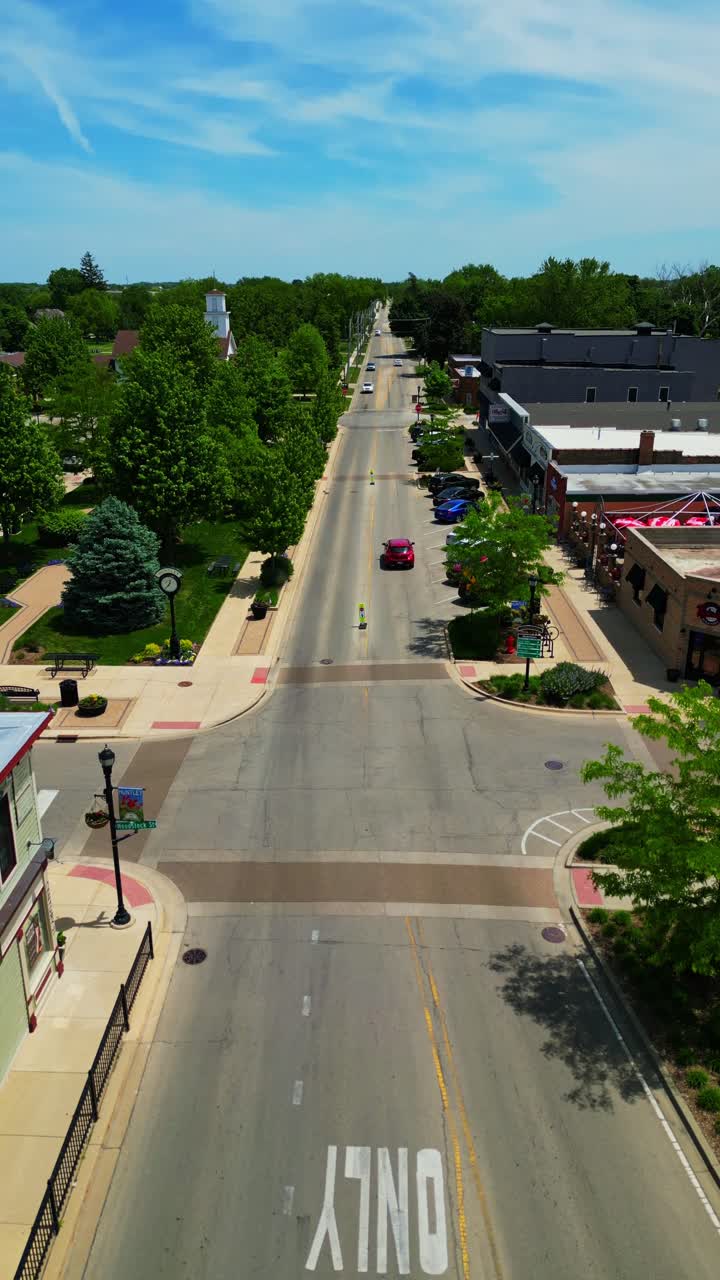 An overhead drone shot captures the charming small-town atmosphere of Huntleys downtown square and main street