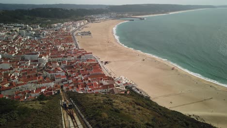 amazing panoramic view of the ocean, beautiful sandy beach, small town and 2 funicular cars