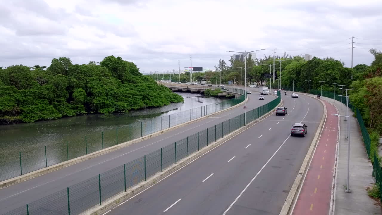 Dynamic aerial footage of Via Mangue expressway in Recife Brazil showing heavy morning car traffic.