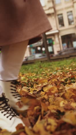 woman walking in autumn leaves