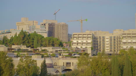 city skyline with construction and hotels
