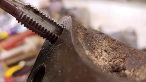 process of threading in metal with drilling machine, close up view