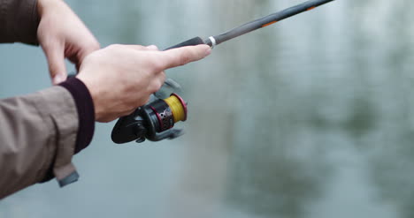 fisherman holding fishing rod in hands 2