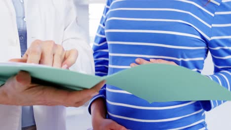 pregnant woman consulting a female doctor