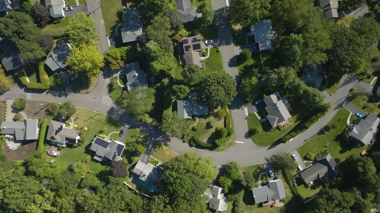 Top down drone shot rising above neighborhood homes, summer day in New York