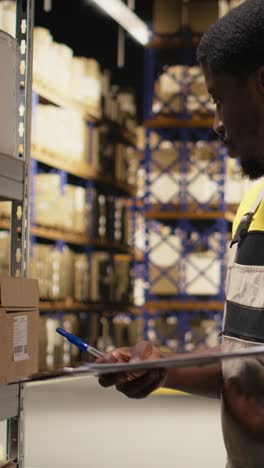 vertical video african american clerk applying shipping labels stickers on packages