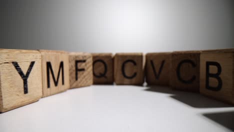 close-up of wooden letter blocks arranged in a curve