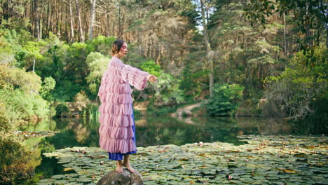 magnetic woman posing nature pond with water lilies. fantasy model dancing pond