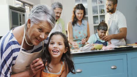 girl interacting with granny while family preparing cookies 4k