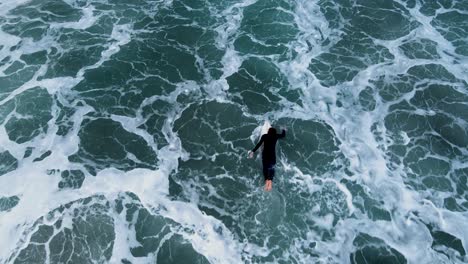 overhead-view-of-an-unrecognizable-short-border-paddling-threw-whitewash