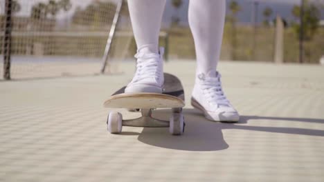 Worms-eye-view-of-skater-wearing-white-gym-shoes