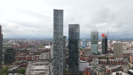 establishing aerial view across tall geometric deansgate manchester downtown cityscape skyscrapers and city centre skyline