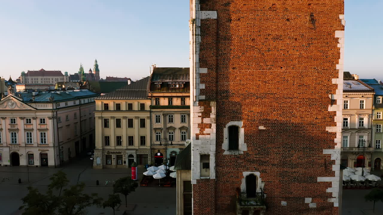 Panorama of Old Town in Krakow, Poland.View on clock on the town hall tower, the Wawel castle, Grodzka street and tenement houses with autumn colors at morning