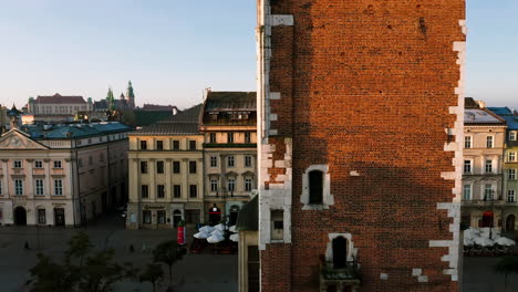 panorama of old town in krakow, poland.view on clock on the town hall tower, the wawel castle, grodzka street and tenement houses with autumn colors at morning