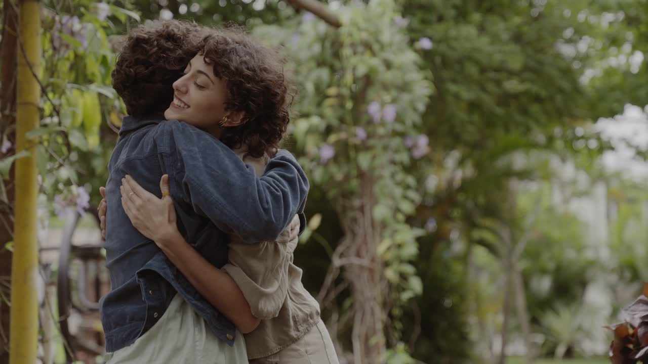 People sharing a warm hug in a garden