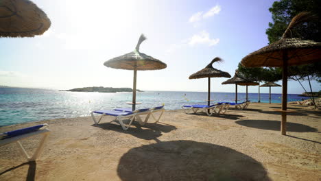 summer parasols all set at mallorca beach spain