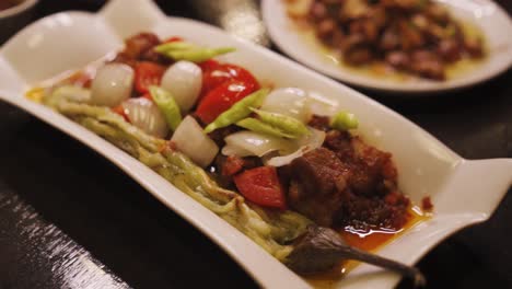 Plate-Of-Pork-Binagoongan-With-Boiled-Eggplant-And-Onion-And-Tomato-Garnishes