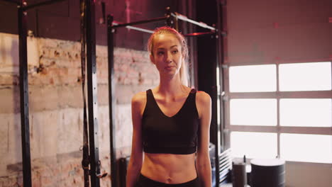 Handheld-Shot-Of-Confident-Young-Woman-Walking-In-Health-Club